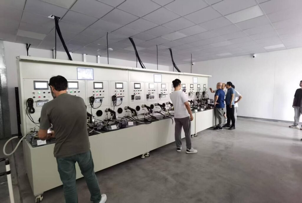 Electrolux team inspecting cleaning appliance performance testing equipment in factory lab